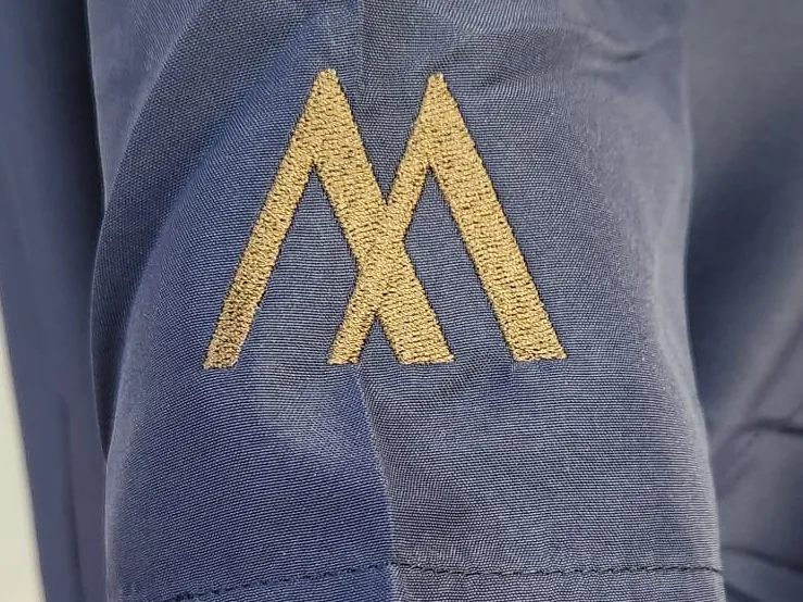 Prenda con logotipo bordado en manga