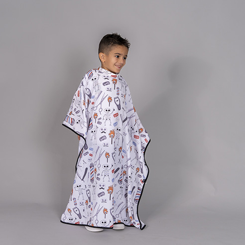 [350002-2001-UD] CAPA PELUQUERÍA INFANTIL ESTAMPADA AJUSTE SEGURO 350002 (2001 HUESOS)